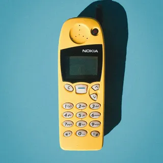 A yellow Nokia 5110 mobile phone